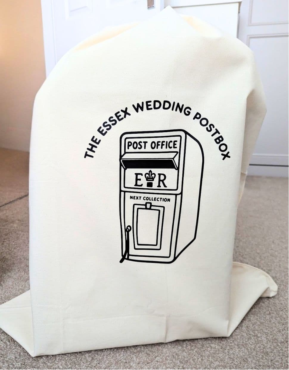 A cream carry bag for the postbox